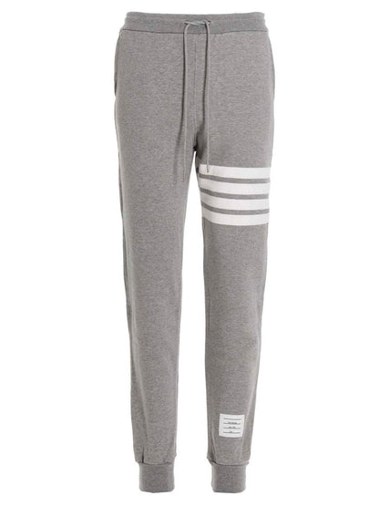 Joggers by Thom Browne for men in cotton gray features a polished silhouette with a polished , reaching a polished long and finished with a polished .