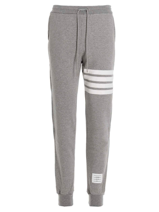 Joggers by Thom Browne for men in cotton gray features a polished silhouette with a polished , reaching a polished long and finished with a polished .