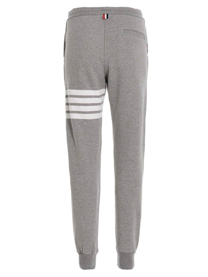 Joggers by Thom Browne for men in cotton gray features a refined silhouette with a refined , defined by a and a refined long for a refined finish.