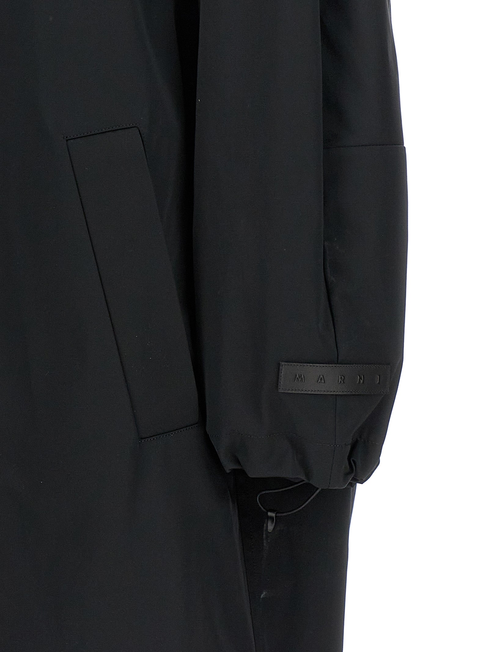 This Hooded Parka by Marni for women in cotton polyester satin black presents a utilitarian silhouette, meticulously detailed with hooded and a utilitarian for a sophisticated, weather-ready look.