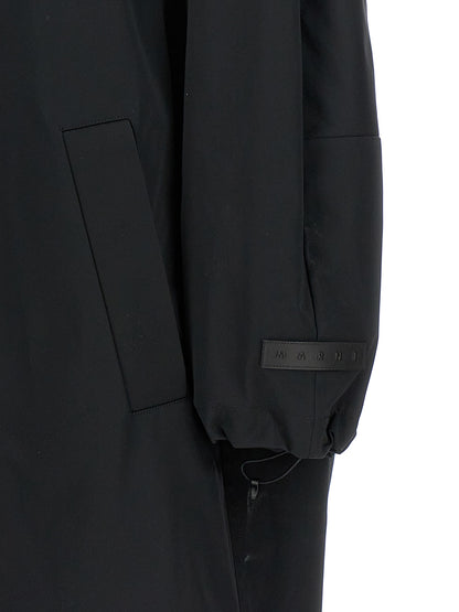 This Hooded Parka by Marni for women in cotton polyester satin black presents a utilitarian silhouette, meticulously detailed with hooded and a utilitarian for a sophisticated, weather-ready look.