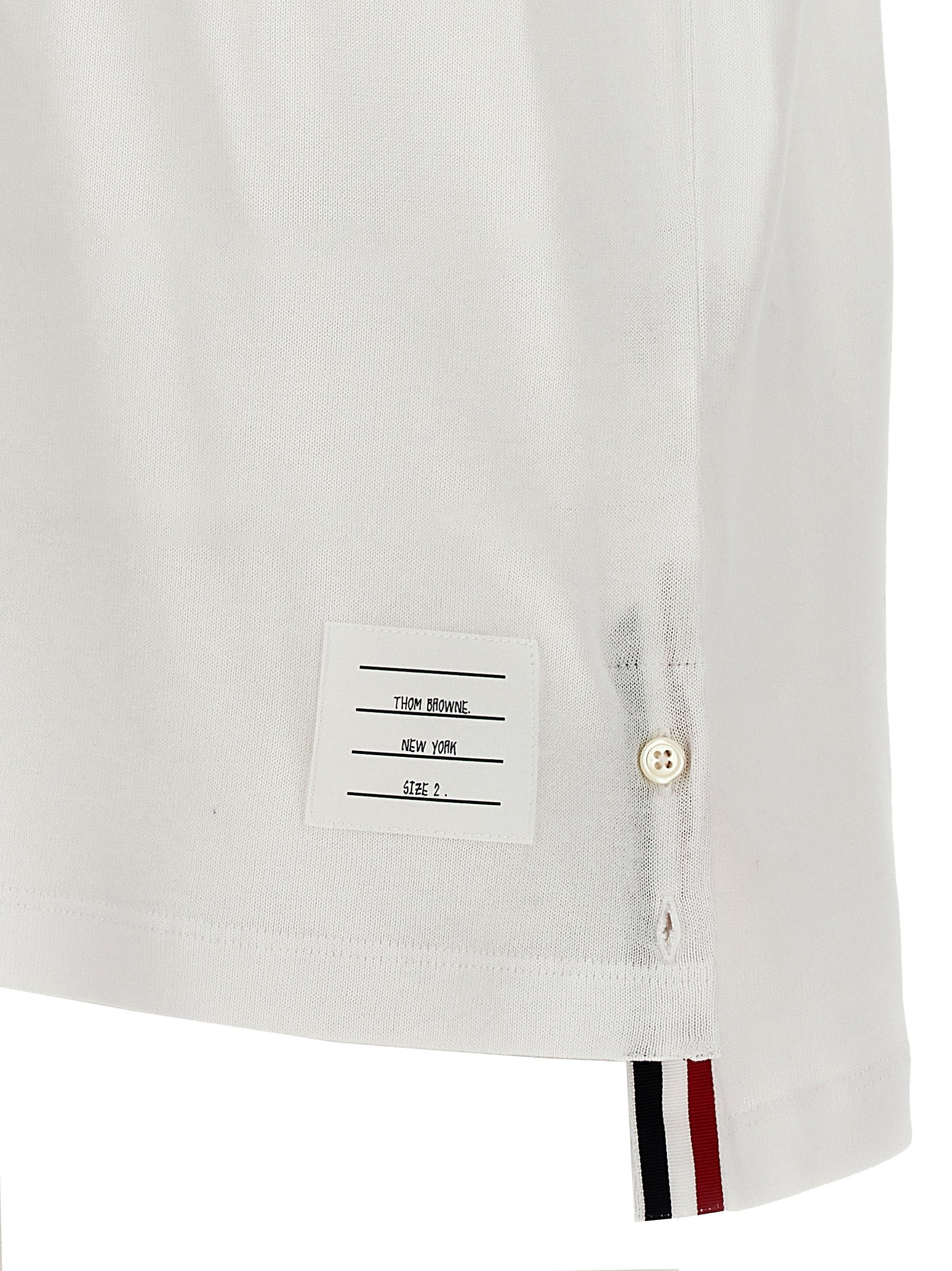 This Polo Shirt by Thom Browne for men in cotton white presents a flawless silhouette, showcasing flawless detailing and a refined for a truly flawless aesthetic.