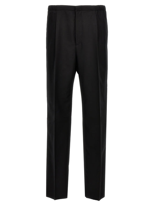 Trousers by Fendi for men in virgin wool black presents a perennial silhouette, meticulously tailored with a straight cut, long finish, and an elegant .