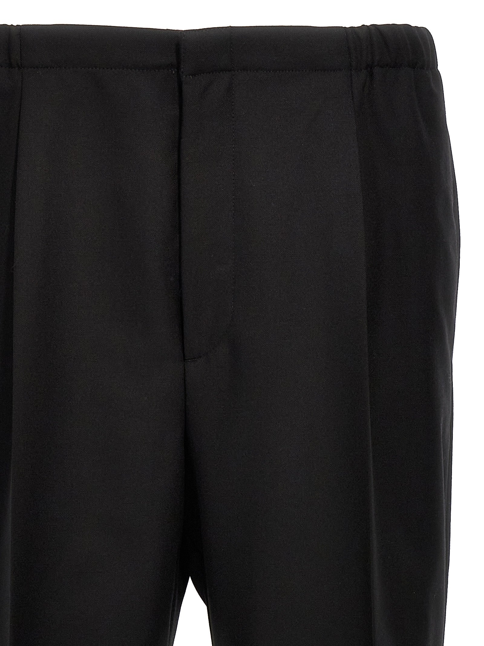 Trousers by Fendi for men in virgin wool black features a tailored silhouette with a tailored straight, defined by its long and a sophisticated .