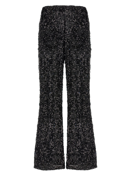 Trousers by LE TWINS for women in polyester & lurex black presents a perennial silhouette, meticulously tailored with a flared cut, long finish, and an elegant .
