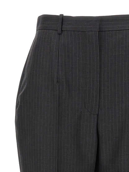 Trousers by Alexander McQueen for women in wool gray & pinstripe presents a perennial silhouette, meticulously tailored with a cut, long finish, and an elegant .