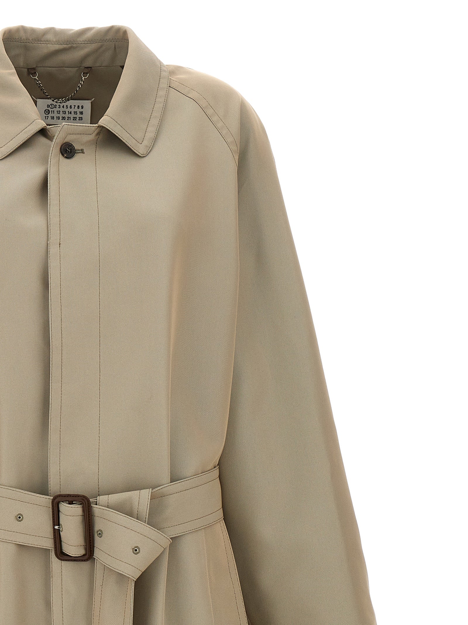 This Maison Margiela men cotton polyester Trench Coat in beige presents a high style silhouette, meticulously detailed with pockets and a high style split neckline for a sophisticated, timeless look.