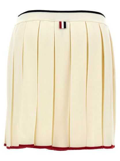 Skirt by Thom Browne for women in virgin wool & polyamide white showcases a sultry silhouette, elegantly defined by its long and the sophisticated sultry design of the Women's Pleated Virgin Wool & Polyamide Long Skirt.