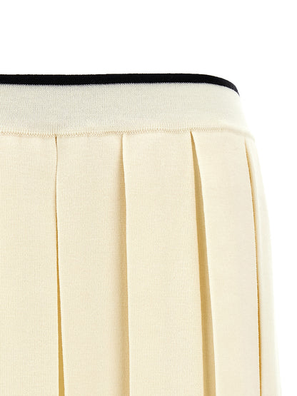 Skirt by Thom Browne for women in virgin wool & polyamide white showcases a dramatic silhouette, artfully capturing the essence of the Women's Pleated Virgin Wool & Polyamide Long Skirt in a dramatic long cut for a refined look.