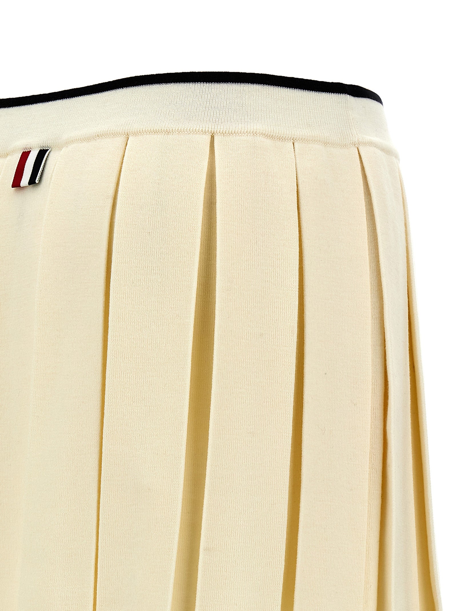 Skirt by Thom Browne for women in virgin wool & polyamide white features a captivating silhouette, showcasing the captivating Women's Pleated Virgin Wool & Polyamide Long Skirt design with a sophisticated long for a captivating look.