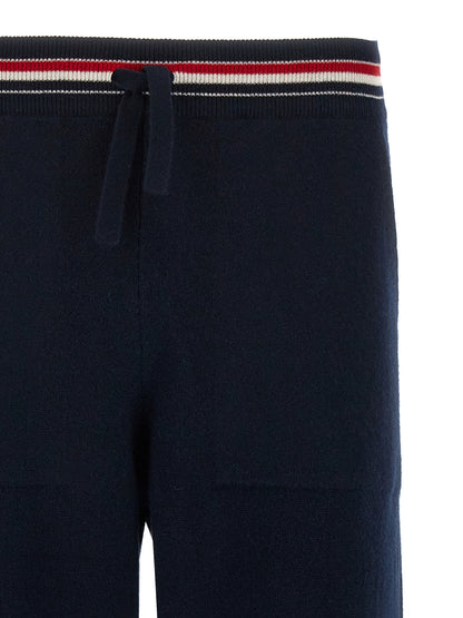 Joggers by Thom Browne for men in cashmere blue features a polished silhouette with a polished , reaching a polished long and finished with a polished .