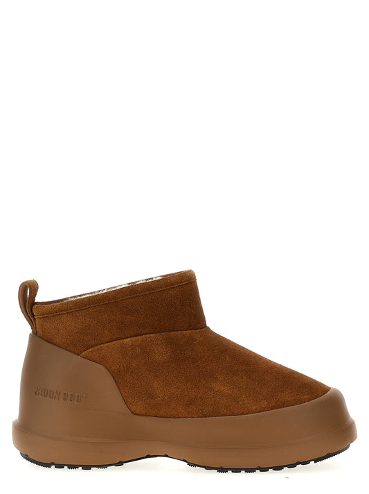 Flat Ankle Winter Boots by Moon Boot for women in bos taurus suede cowhide leather & fur brown showcases a ergonomic silhouette from the Women's Bos Taurus Suede Cowhide Leather & Fur Flat Ankle Winter Boots collection, featuring a ergonomic flat and a ergonomic .