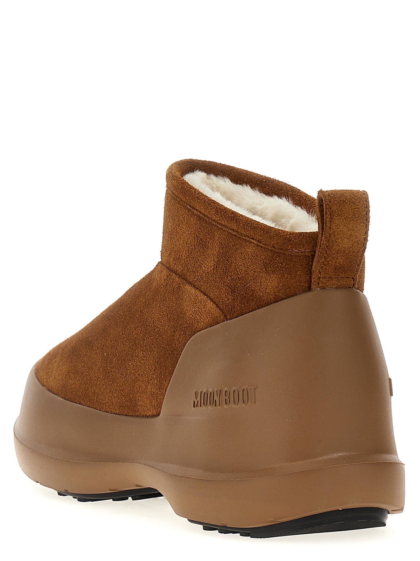 Flat Ankle Winter Boots by Moon Boot for women in bos taurus suede cowhide leather & fur brown features an high-performance silhouette, showcasing the sophisticated design of the Women's Bos Taurus Suede Cowhide Leather & Fur Flat Ankle Winter Boots with a flat and a refined .