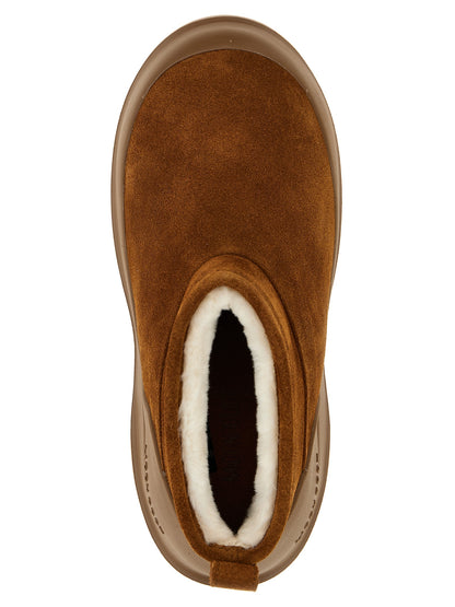 Flat Ankle Winter Boots by Moon Boot for women in bos taurus suede cowhide leather & fur brown showcases a impeccable silhouette as Women's Bos Taurus Suede Cowhide Leather & Fur Flat Ankle Winter Boots, artfully defined by a impeccable flat and a impeccable .
