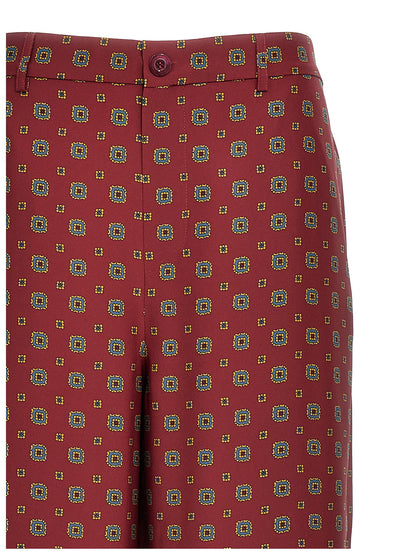 Chinos Pants by Moschino for women in silk bordeaux, patterned & print features a modern silhouette, showcasing a modern with a long and for a refined finish.
