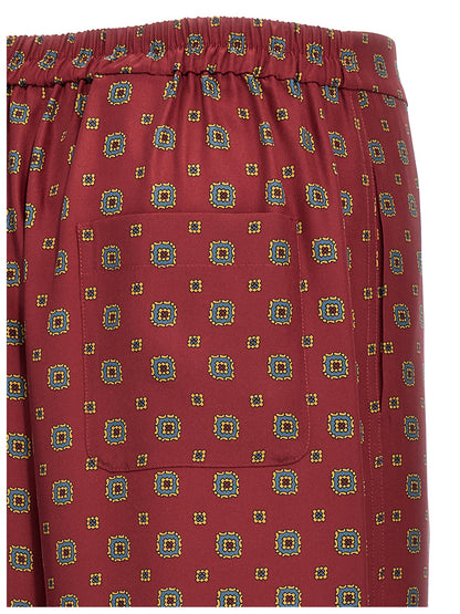 Chinos Pants by Moschino for women in silk bordeaux, patterned & print presents a sartorial luxe silhouette, showcasing a sophisticated with a long and for a premium, sartorial luxe finish.