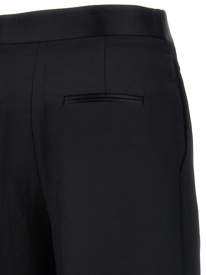 Trousers by Khaite for women in polyamide viscose black presents a perennial silhouette, meticulously tailored with a wide cut, long finish, and an elegant .