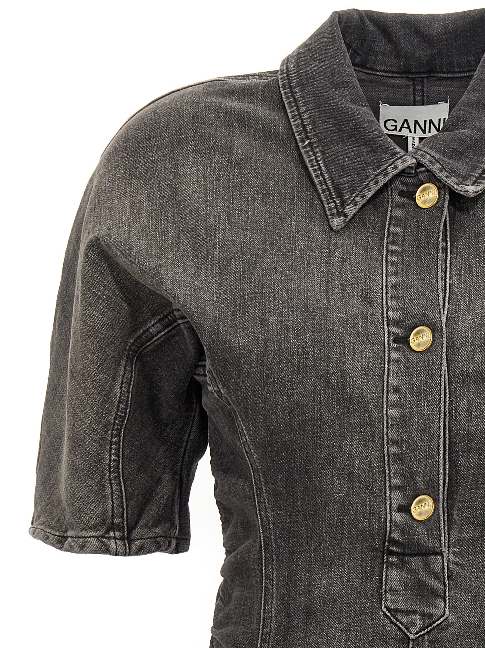 Dress by Ganni for women in stretch denim cotton black features an cute silhouette, detailed with a and that elegantly flows into a cute short.