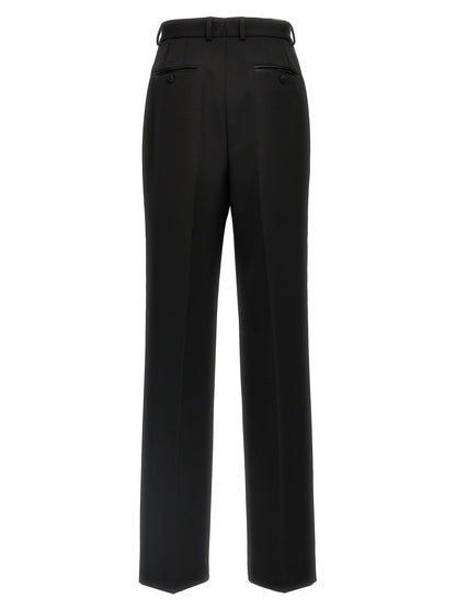 Trousers by Dolce & Gabbana for women in virgin wool polyester & silk black features a tailored silhouette with a tailored , defined by its long and a sophisticated high rise.