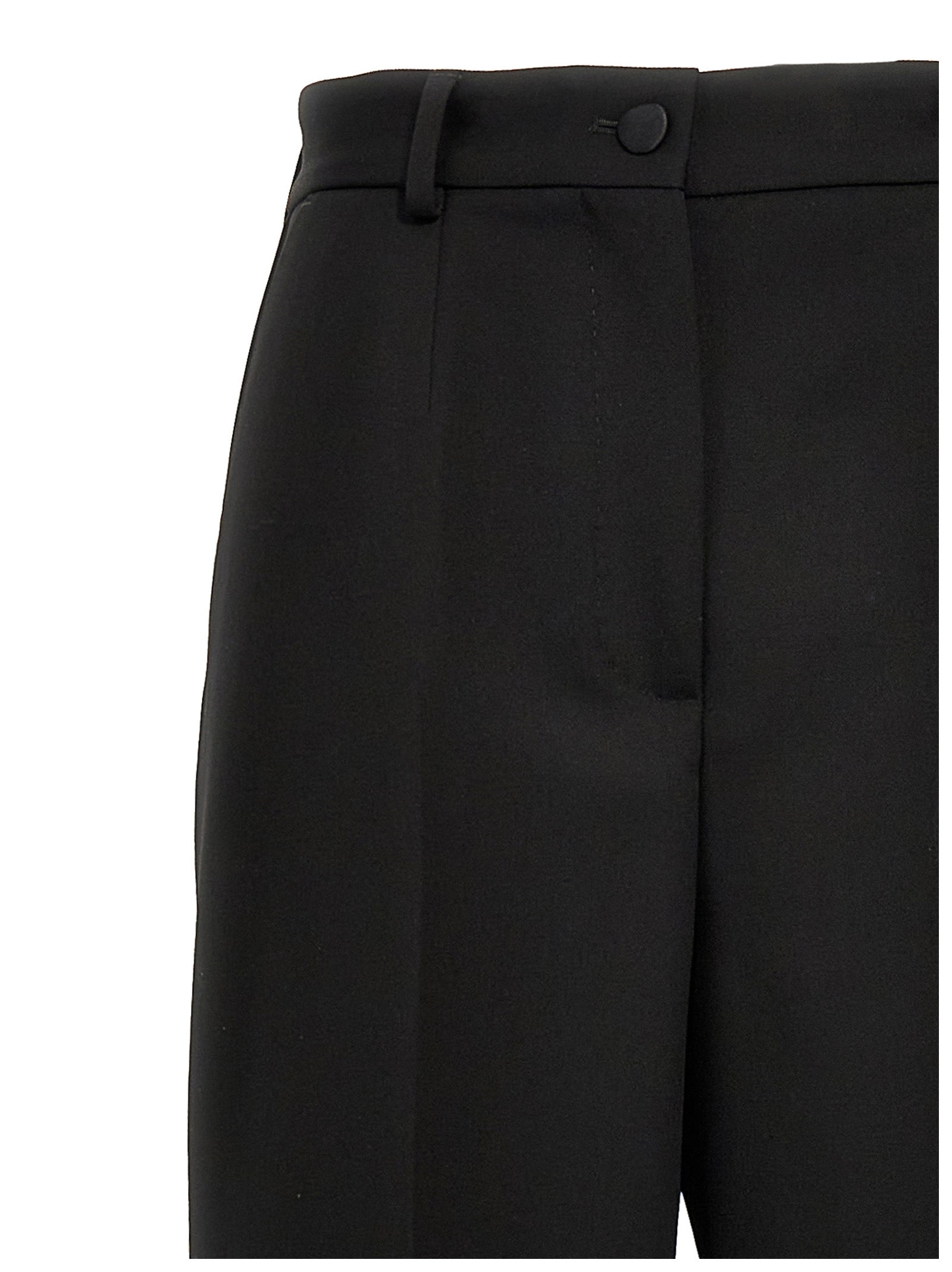 Trousers by Dolce & Gabbana for women in virgin wool polyester & silk black features an sartorial silhouette, showcasing a precise and long with a sartorial high rise for a refined look.