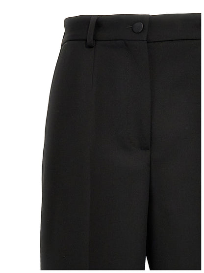 Trousers by Dolce & Gabbana for women in virgin wool polyester & silk black features an sartorial silhouette, showcasing a precise and long with a sartorial high rise for a refined look.
