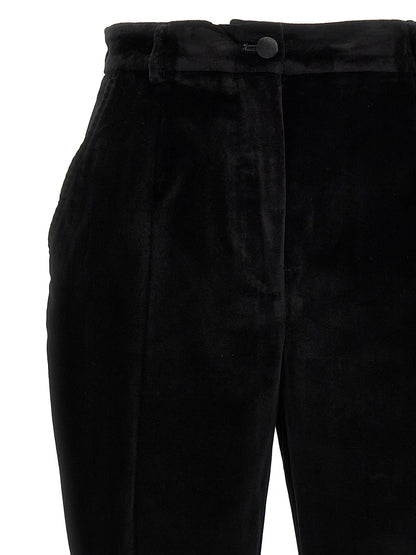 Trousers by Dolce & Gabbana for women in polyester cotton & silk black features a sculptural silhouette, showcasing a sculptural and long with a sophisticated for a sculptural finish.