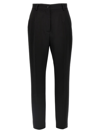 Trousers by Dolce & Gabbana for women in virgin wool polyester & silk black presents a smart silhouette, meticulously detailed with a smart , a smart long, and a smart high rise.