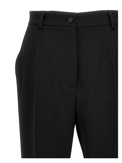 Trousers by Dolce & Gabbana for women in virgin wool polyester & silk black features a tailored silhouette with a tailored , defined by its long and a sophisticated high rise.