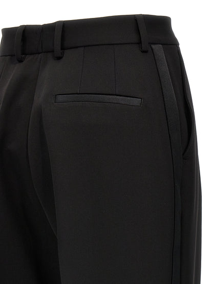 Trousers by Dolce & Gabbana for women in virgin wool polyester & silk black features an on trend silhouette, showcasing a sophisticated with a long and high rise for an on trend finish.