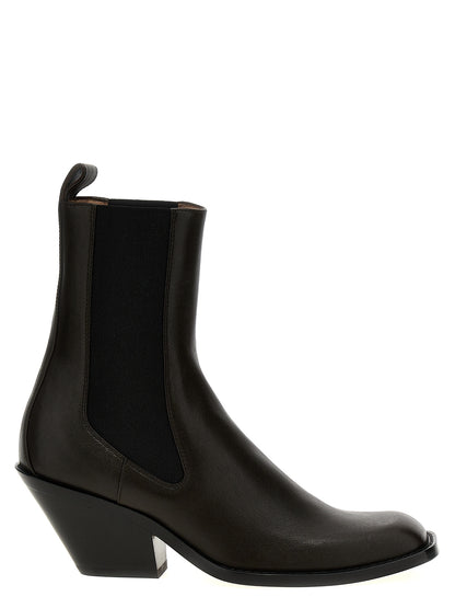 Ankle Chelsea Strap Boots by Khaite for women in bos taurus calfskin leather brown features an avant-garde Women's Bos Taurus Calfskin Leather Ankle Chelsea Strap Boots silhouette, defined by a sophisticated and a avant-garde square toe style.