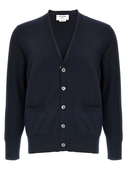 Cardigan by Thom Browne for men in cotton blue & signature features a dramatic silhouette, showcasing a sophisticated v-neck neckline and dramatic detail for a timeless, premium look.