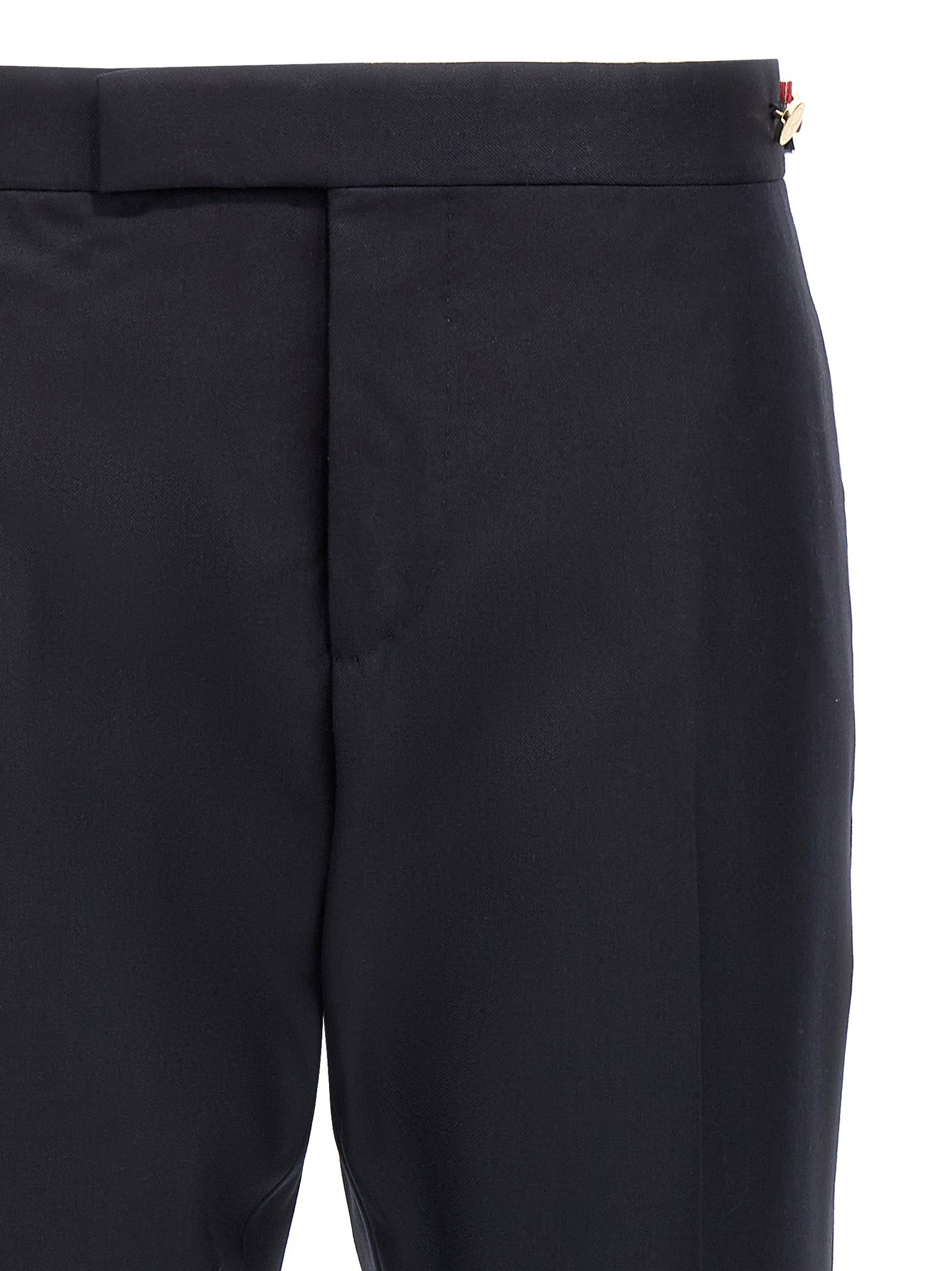 Trousers by Thom Browne for men in wool twill blue presents a smart silhouette, meticulously detailed with a smart straight-leg, a smart long, and a smart low rise.