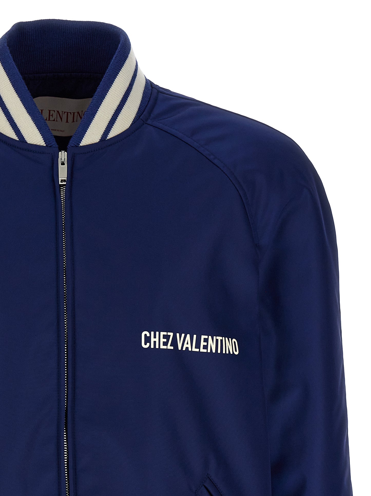This Bomber Jacket by Valentino Garavani for men in polyamide blue & print exhibits a edgy silhouette, meticulously detailed with functional pockets & insulated and a edgy for a edgy finish.