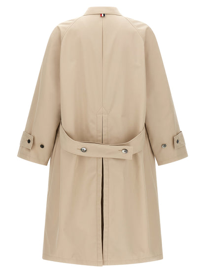 Trench Coat by Thom Browne for men in polyester polyurethane cotton and beige presents a exquisite silhouette, showcasing a exquisite and functional pockets for an elevated aesthetic.