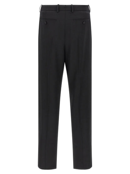 Trousers by Saint Laurent for men in satin wool black features an sartorial silhouette, showcasing a precise and long with a sartorial high rise for a refined look.