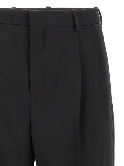 Trousers by Saint Laurent for men in satin wool black features a artisanal silhouette, showcasing a sophisticated with a long and high rise for a artisanal finish.