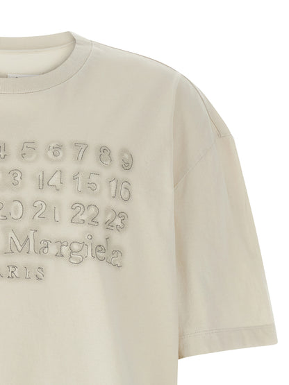 T-Shirt by Maison Margiela for men in cotton beige & print showcases a dramatic silhouette, elegantly detailed with a dramatic and for a truly dramatic finish.