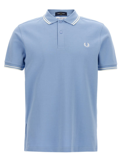 Polo Shirt by Comme Des Garçons for men in cotton light-blue & print presents a crisp silhouette, artfully detailed with a crisp short-sleeve and crisp .