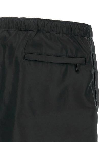 Swim Shorts by Valentino Garavani for men in nylon & mesh black features a beach chic silhouette, showcasing the signature style of the Heart Men's Nylon & Mesh Swim Shorts.