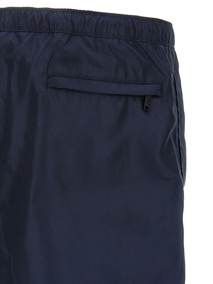Swim Shorts by Valentino Garavani for men in nylon & mesh blue features a riviera-ready silhouette, showcasing the Men's Nylon & Mesh Swim Shorts design for a premium look.