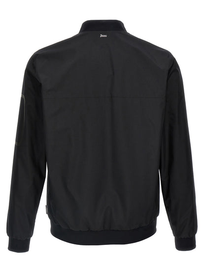 This Bomber Jacket by Herno for men in polyester black exhibits a edgy silhouette, meticulously detailed with functional breathable-design, windproof & pockets and a edgy for a edgy finish.