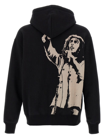 Sweatshirt Hoodie by Junya Watanabe for men in cotton black & print features a slouchy chic silhouette, detailed with a slouchy chic and a signature hooded neckline for an elevated aesthetic.