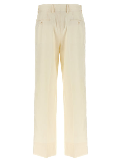 Trousers by Brioni for women in linen silk & wool white, patterned & herringbone presents a perennial silhouette, meticulously tailored with a straight-leg cut, long finish, and an elegant .