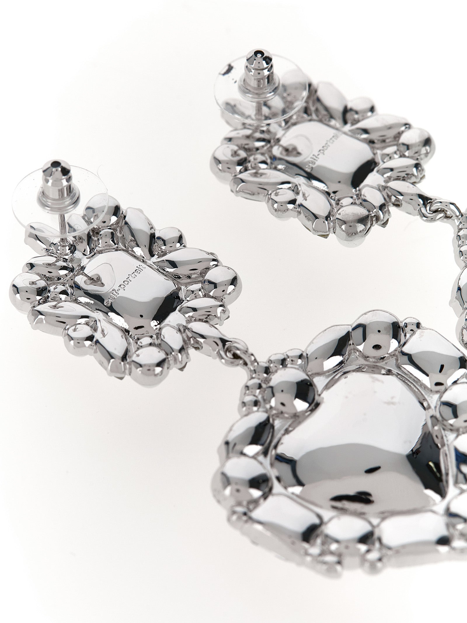 Earrings by Self-Portrait for women in virgin wool pearl & silver presents a curated silhouette, artfully showcasing the curated and refined aesthetic of the Heart Women's Pearls Crystal & Brass Earrings.