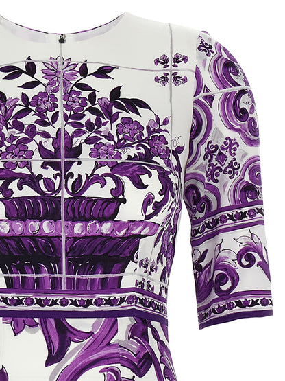 Dress by Dolce & Gabbana for women in silk purple & print features an cute silhouette, detailed with a and round neckline that elegantly flows into a cute midi.
