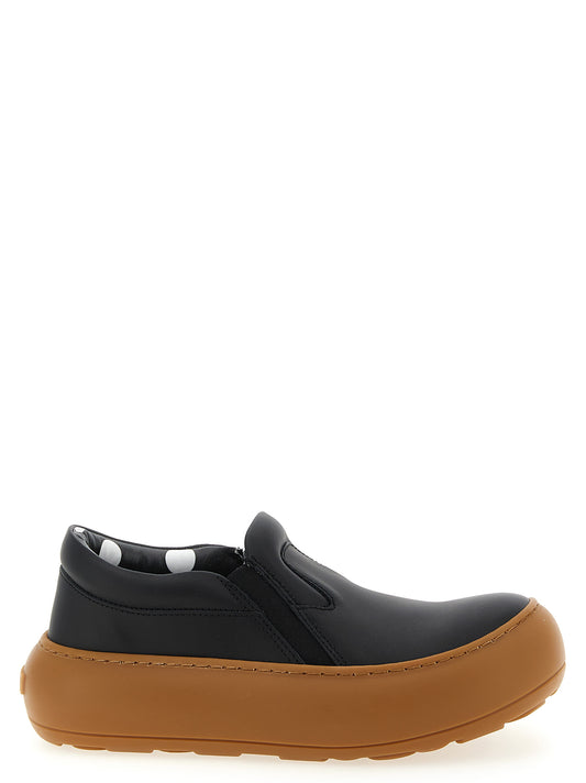 Sneakers by Moschino for women in leather & rubber black & print presents a sumptuous silhouette, artfully capturing the essence of the Ollie Women's Slip On Chunky Leather & Rubber Sneakers with its sumptuous slip-on chunky style design.