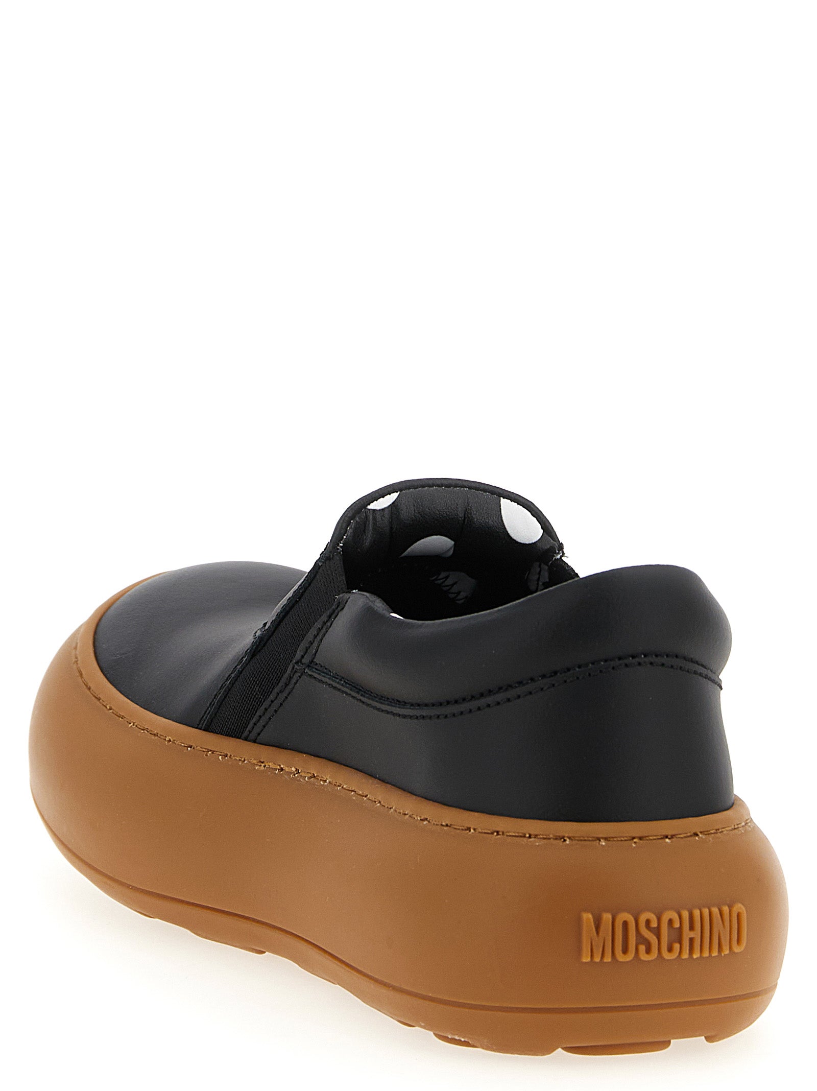 Sneakers by Moschino for women in leather & rubber black & print presents a on trend silhouette from the Ollie Women's Slip On Chunky Leather & Rubber Sneakers collection, showcasing a on trend slip-on chunky style for an elevated aesthetic.