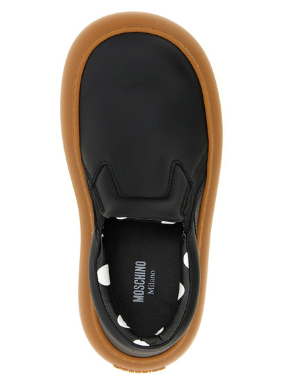 Sneakers by Moschino for women in leather & rubber black & print features an timeless silhouette from the Ollie Women's Slip On Chunky Leather & Rubber Sneakers collection, showcasing a signature slip-on chunky style with an timeless finish.