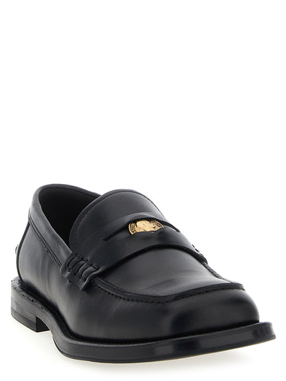 Loafer Slip-On Shoes by Moschino for men in leather & velvet black features an effortless chic silhouette, showcasing the Men's Leather & Velvet Loafer Slip-On Shoes design with an effortless chic and a for a effortless chic look.