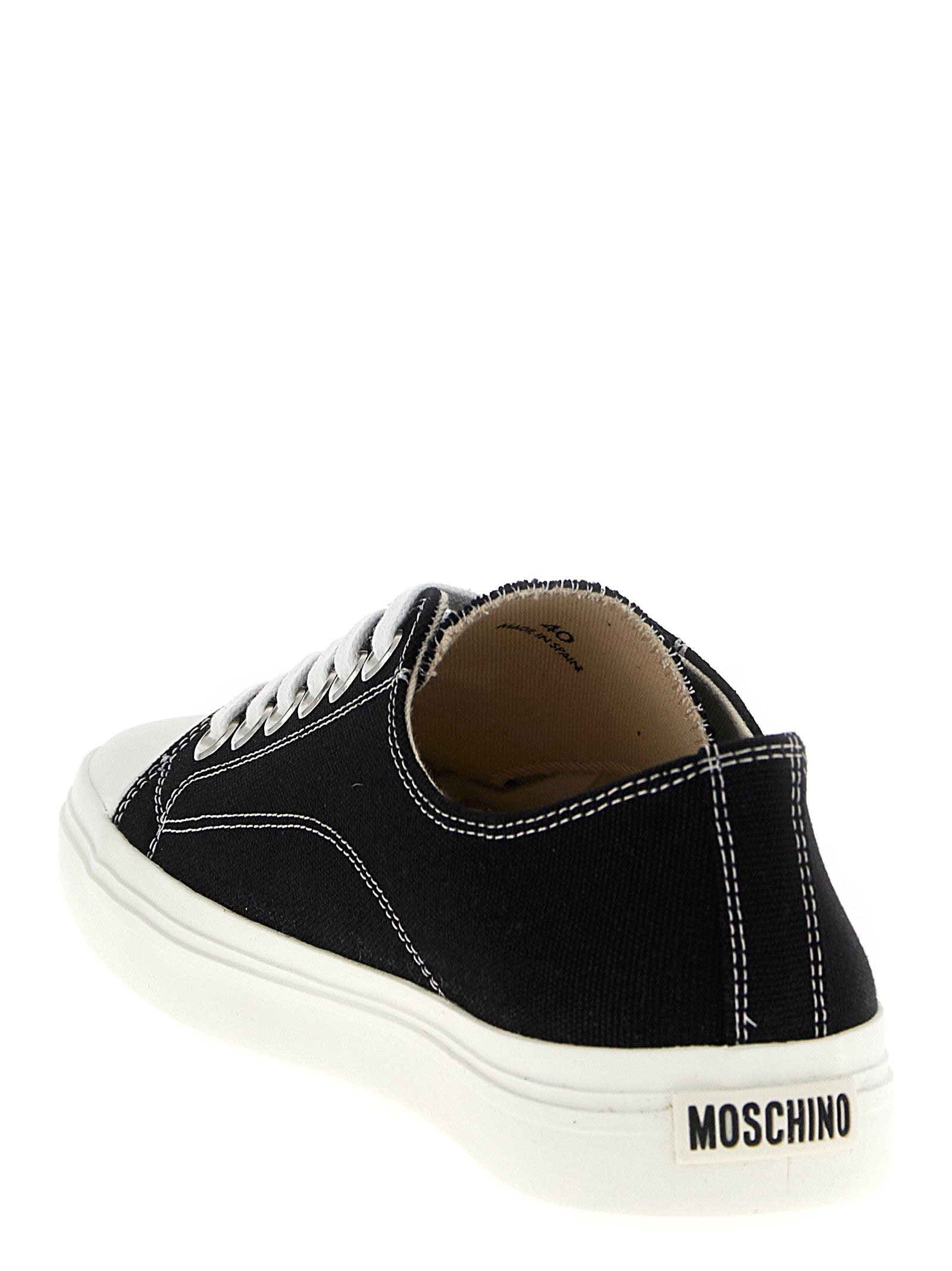 Sneakers by Moschino for men in cotton canvas bicolour, black & white features an timeless silhouette from the Men's Fashion Cotton Canvas Sneakers collection, showcasing a signature fashion style with an timeless finish.